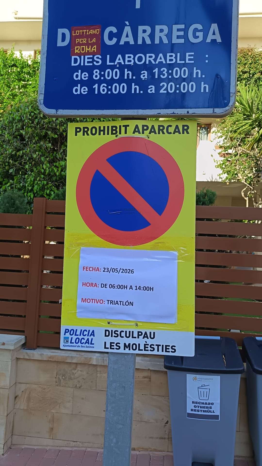 Loading-zone sign and a temporary no-parking sign for an event in Colònia de Sant Jordi